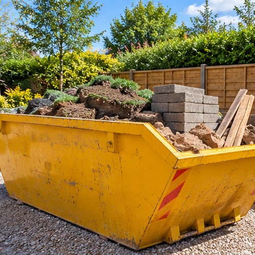 Yellow skip containing soil and renovation materials